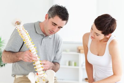 Chiropractor explaining about spinal chord to his patient