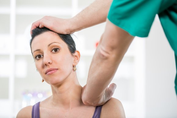 Chiropractor giving treatment to a lady