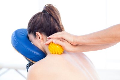 Chiropractor massaging a lady patient